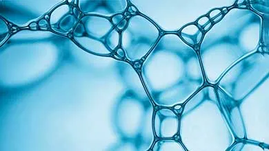 Close-up of blue bubbles connected in a geometric, web-like pattern.