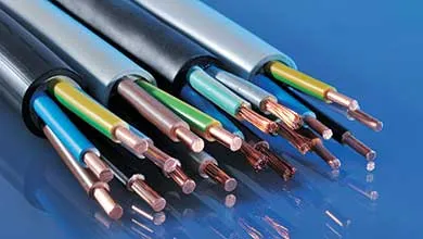 Several black and grey electrical cables with stripped ends rest on a shiny blue surface, exposing colorful insulated wires and bare copper conductors.