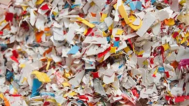 Close-up of a large pile of shredded plastic pieces in various colors.