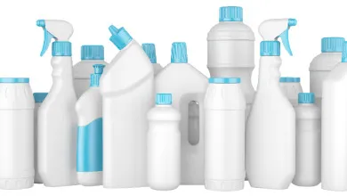 Several white plastic cleaning bottles and containers with light blue lids and spray tops, arranged on a white background.